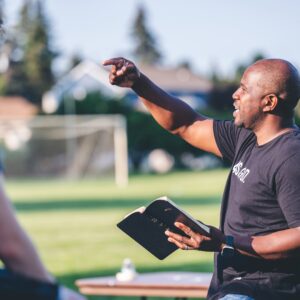 man in black crew neck t-shirt holding black tablet computer
